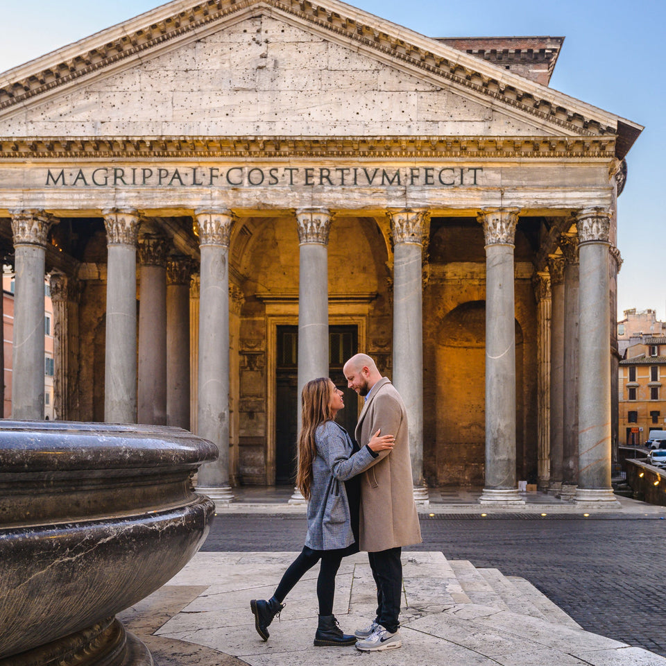 Couple embracing in front of the Pantheon in Rome, Italy.